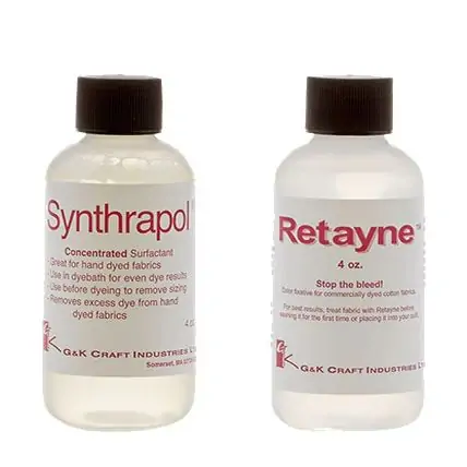Two clear plastic bottles with white caps are shown. The left bottle is labeled Synthrapol, and the right bottle is labeled Retayne. Both are dye-related fabric care products from G&K Craft Industries.