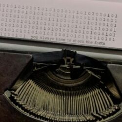 Photo by Ron Lach Vintage typewriter typing binary code with a quote about fact-checking.