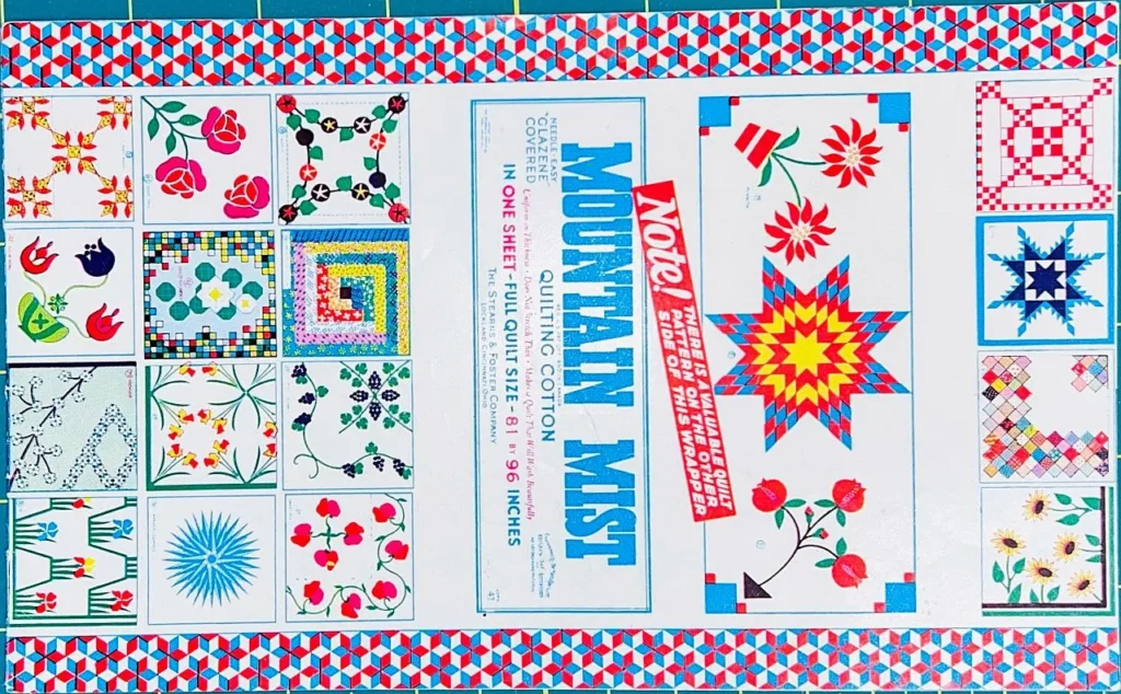 A colorful sheet features assorted quilt patterns, including flowers, stars, geometric designs, and a label reading “Mountain Mist.” The border has a red, white, and blue geometric print.