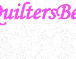 The image shows the word QuiltersBee in large, pink, cursive font on a white background with a subtle, speckled pattern.