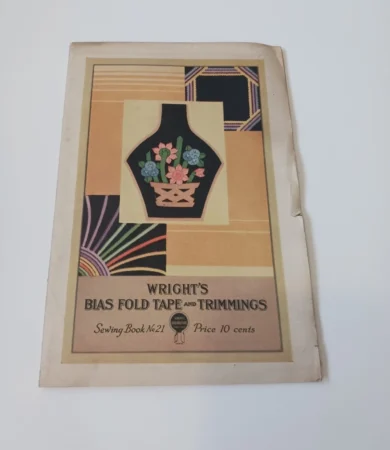 Vintage cover of Wrights Bias Fold Tape and Trimmings Sewing Book No 21, priced at 10 cents, featuring a stylized vase with flowers and geometric patterns in yellow, pink, purple, and green.