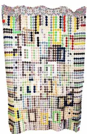 Patterned-yo-yo A handmade quilt featuring a grid of colorful circular fabric patches arranged in rows and columns, forming various patterns on a white background.