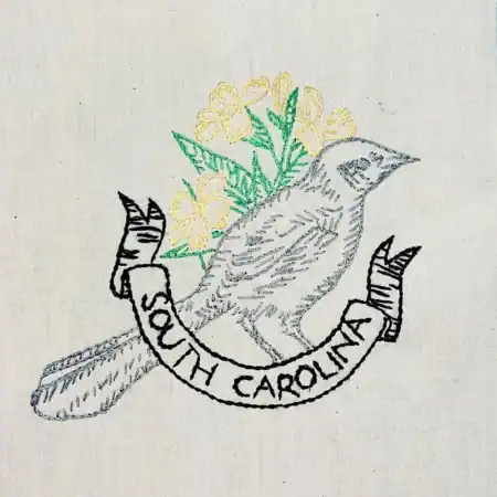 South-Carolina-Carolina-mockingbird Embroidery of a bird with yellow flowers in the background and a banner reading South Carolina below the bird.