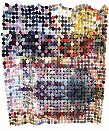 colorful-yoyo A quilt made of hundreds of circular, colorful fabric patches arranged in a loose grid with a wavy, uneven edge, featuring a variety of patterns and shades across the surface.