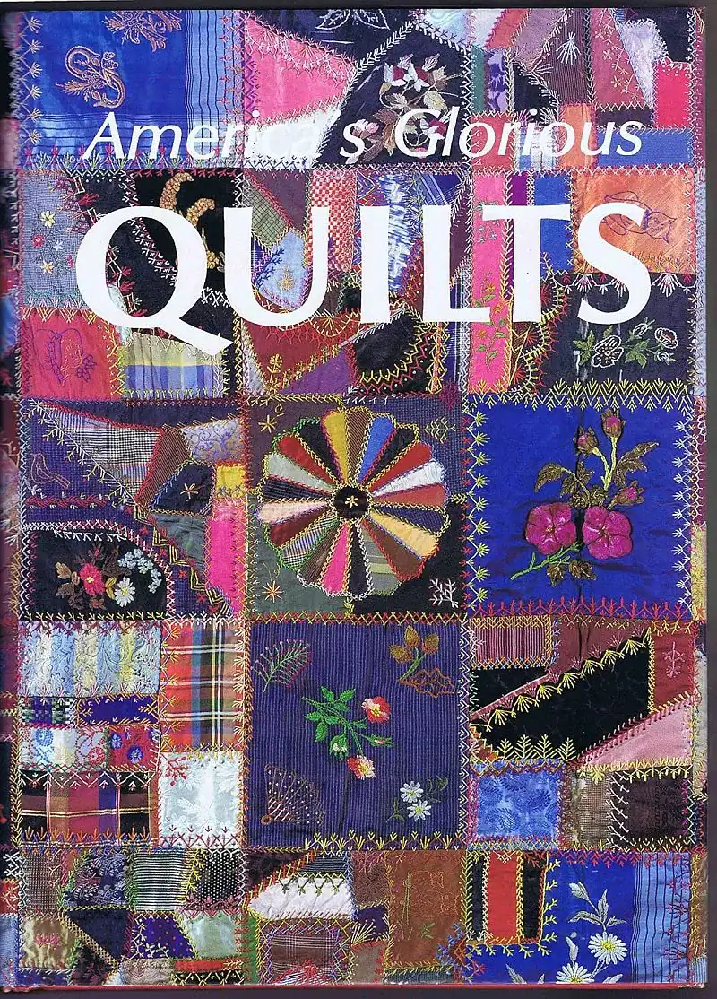 A colorful patchwork quilt featuring various intricate patterns and embroidery, with large white text overlaid that reads Americas Glorious QUILTS..