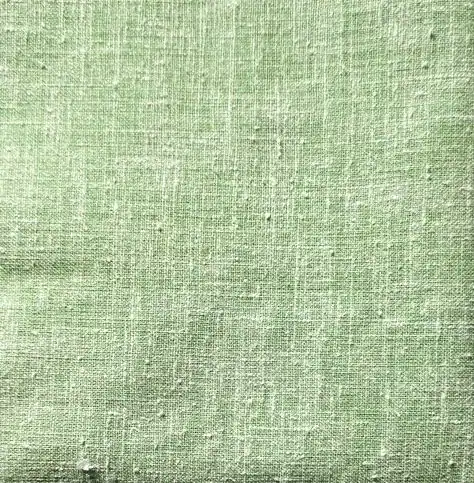 kettle-cloth Light green fabric with a visible woven texture and subtle irregular lines, giving it a slightly rough, natural appearance. The surface has small imperfections and a matte finish.