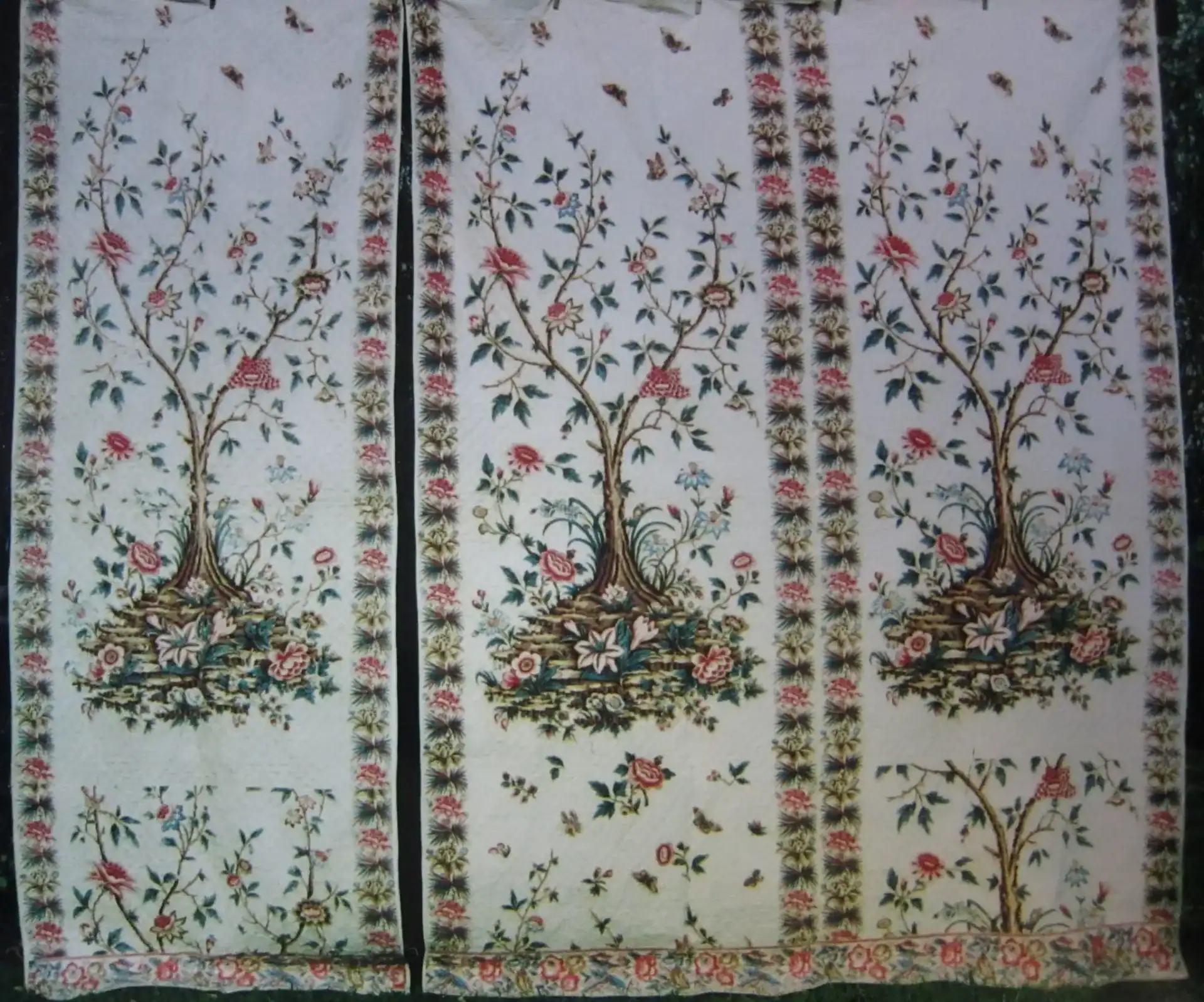 Three fabric panels feature a decorative floral tree design with colorful flowers, leaves, and birds, bordered by a floral pattern on all sides. The main tree motif appears in each panel, set against a light background.