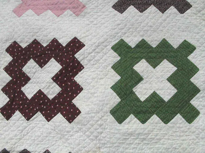 Close-up of brown and green album blocks with fine hand quilting on the 1852 quilt