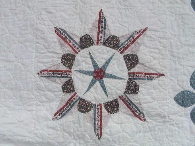 Close-up of an applique star with petals cut from striped fabric