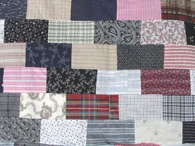 Close-up of the brick quilt top showing plaids, stripes and calico prints