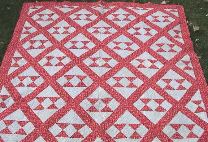 Red and white quilt top with pieced triangle blocks set on point
