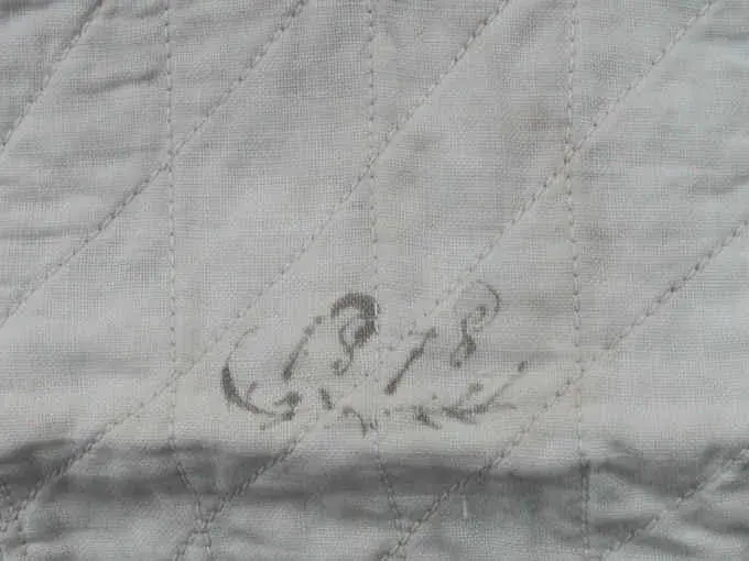Ink date 1878 written in a white block of the indigo doll quilt