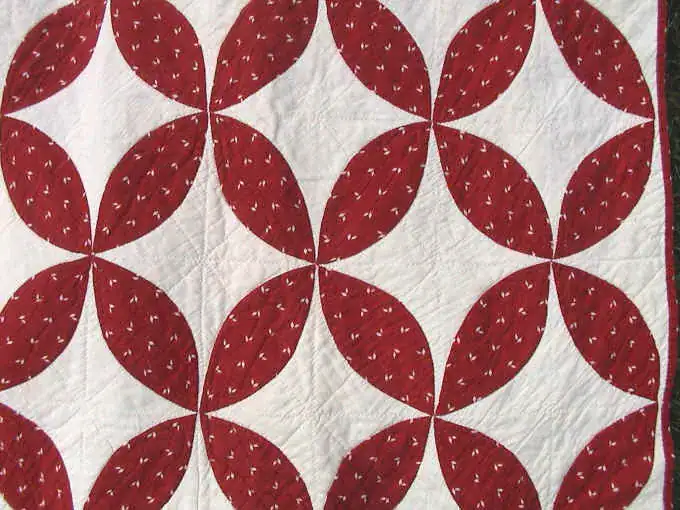 Close-up of red print orange peel shapes on a white ground